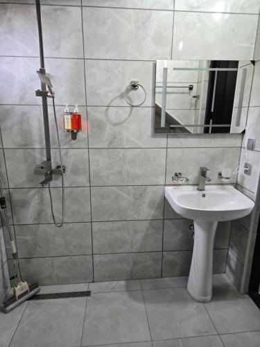 a bathroom with a sink and a shower at Blue Horizon Apartments in Ureki