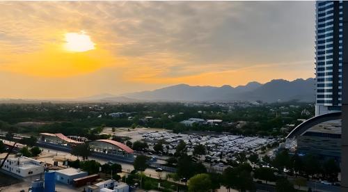 a view of a city with the sun setting at Elysium Tower Premium Hotel Serviced Apartments Islamabad in Islamabad