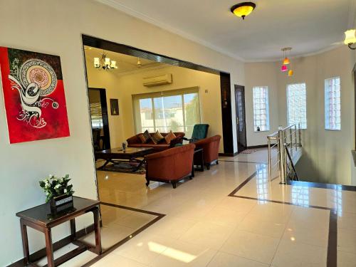 a living room with a couch and a table at Eden Grove Villa in Rawalpindi