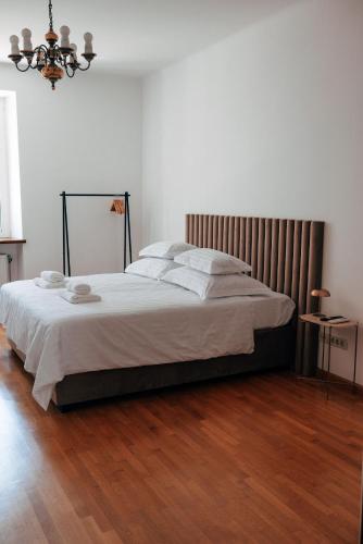 a bedroom with a large bed with a wooden floor at Nono Ban West Coast in Split