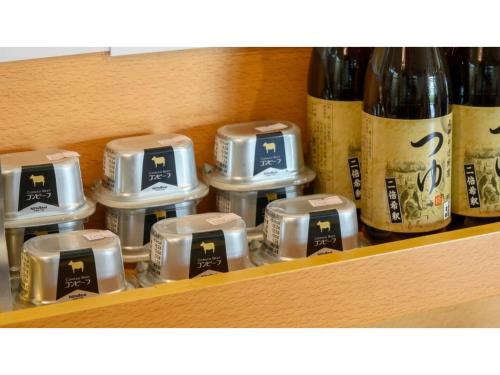 a shelf with six different bottles of wine at Hotel Symphony - Vacation STAY 31586v in Sagae