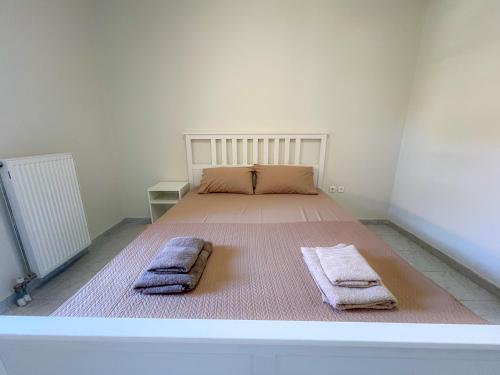 a bedroom with a bed with two towels on it at Cosy Stay Apartment with Sea View in Kalandra