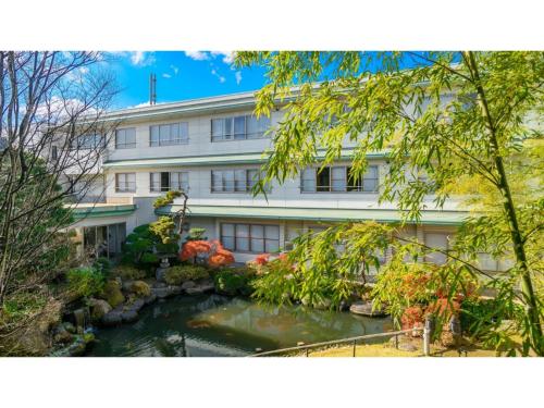 a building with a pond in front of it at Hotel Symphony - Vacation STAY 31586v in Sagae