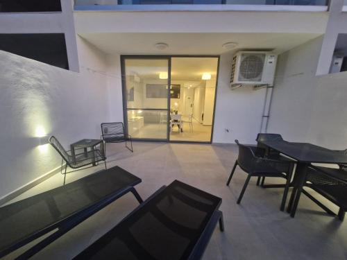 a room with chairs and a piano in a building at GOZO DIVE Residence in Xlendi