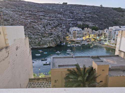a view of a harbor with boats in the water at GOZO DIVE Residence in Xlendi