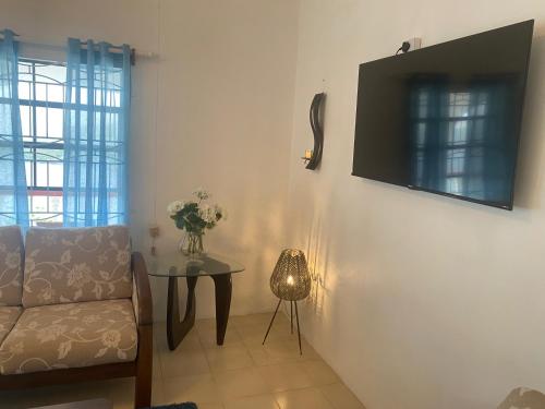 a living room with a couch and a table at Immaculate 3 Bed Villa Overlooking Admiralty Bay in Union