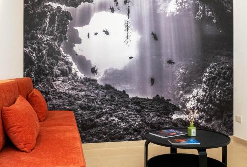 a living room with a couch and a table at GOZO DIVE Residence in Xlendi