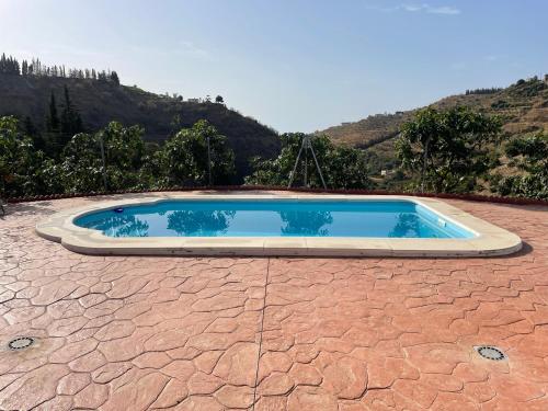 a swimming pool on top of a red brickickedickedickedickedickedickedicked at TIERRA NUEVA Familiar experience in Torre de Benagalbón