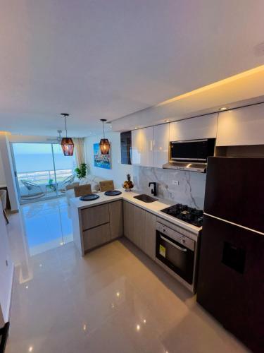 a large kitchen with a stove and a refrigerator at Luxury apartment with sea view in Cartagena de Indias