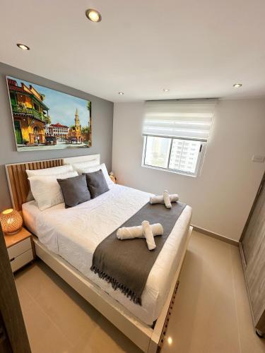 a bedroom with a bed with a stuffed animal on it at Luxury apartment with sea view in Cartagena de Indias