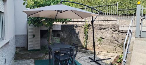 a table and chairs under an umbrella on a patio at Nonna ITA in Albino