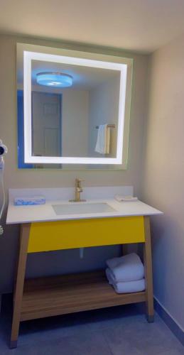 a bathroom with a sink and a mirror at Days Inn by Wyndham Reno in Reno