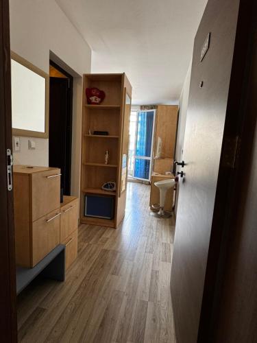 a room with a bathroom with a sink and a door at Aurora 1 Bedroom beach Apartment in Nesebar