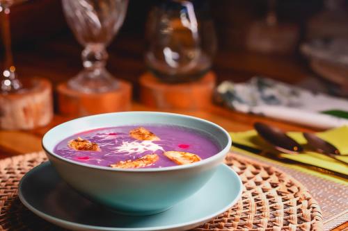 a bowl of soup on a plate on a table at Burú Nature Hotel in Leticia
