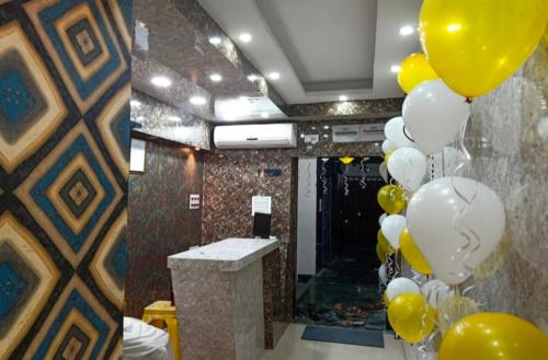 a bunch of yellow and white balloons in a room at Hotel Sana a family-friendly guest house in Kolkata