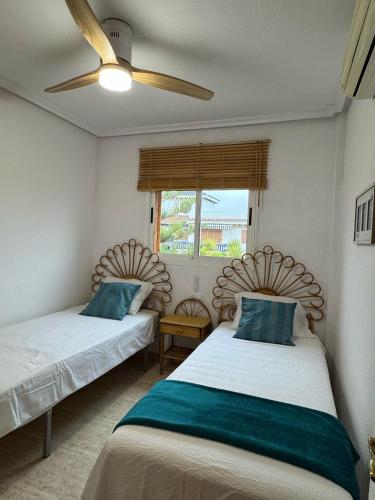 a bedroom with two beds and a ceiling fan at vera home shine in Vera