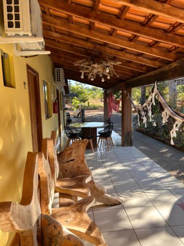 a patio with chairs and a table and a ceiling at Pousada Cantinho de Casa in Nobres