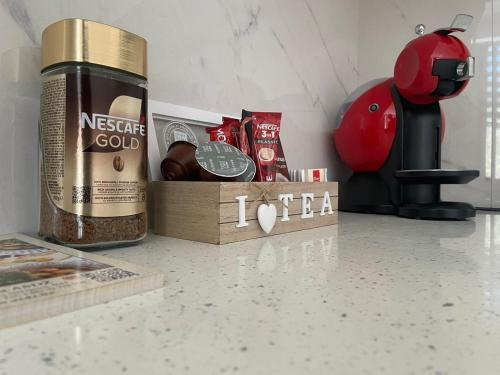 a bottle of coffee on a counter next to a coffee maker at Latin Bridge Residence in Sarajevo