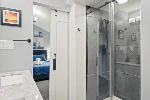 a shower with a glass door in a bathroom at Lakeside Haven Ping Pong Fire Pit Mins to Big Boulder Lake Harmony in Lake Harmony