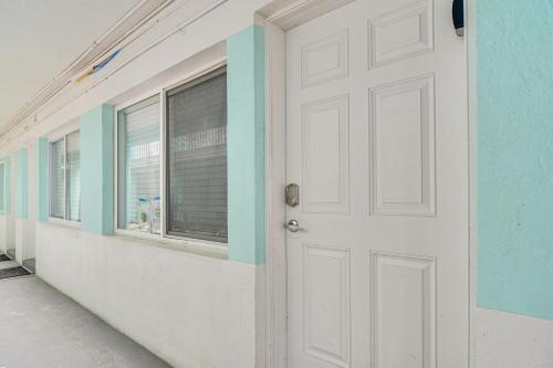 a white door in a room with windows at Bright Gulf Coast Escape - 8 Mi to Johns Pass! in St Pete Beach