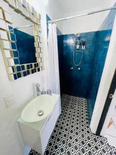 a bathroom with a white sink and a shower at Nueva Vista INN in Cruz de Huanacaxtle