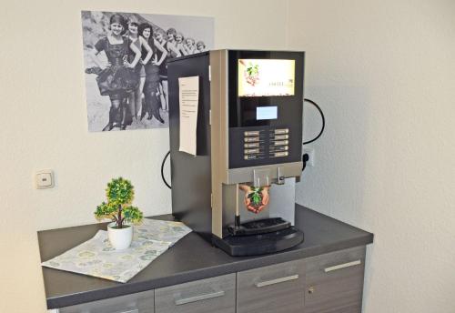 a coffee machine sitting on top of a dresser at Appartementhaus Sellin in Ostseebad Sellin