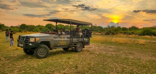 a group of people riding in a jeep at Thornicroft Lodge - South Luangwa in Mpanda