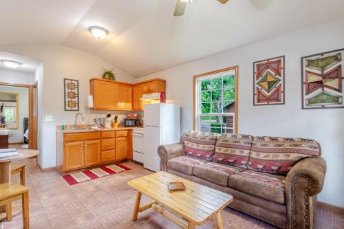 a living room with a couch and a kitchen at Qualla Cabins and Motel Cherokee near Casino in Whittier