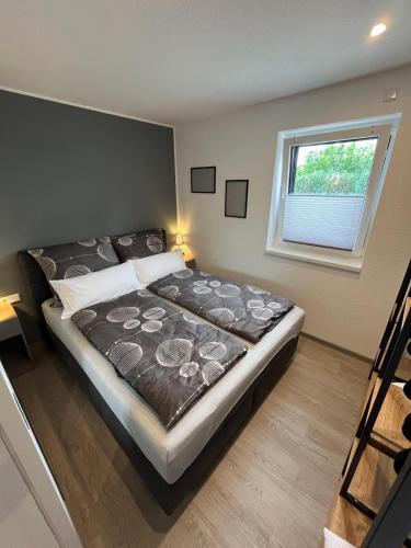a large bed in a room with a window at Ferienhaus Jannik in Hüde