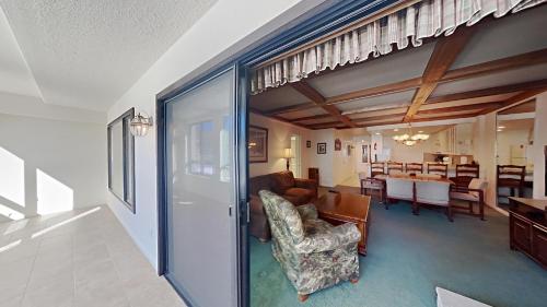 a living room with a couch and a dining room at Comfortable Condo - Gorgeous Slopeview and Access to 3 Hot Tubs Unit 303 at 1849 in Mammoth Lakes