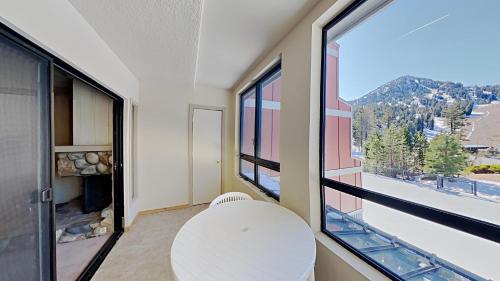 a room with a white table and a large window at Beautiful 2 BR Condo with Mountain View! in Mammoth Lakes