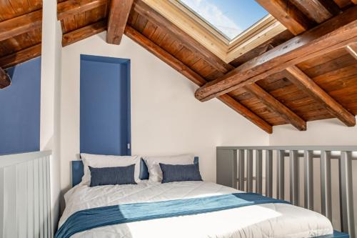 a bedroom with a bed and wooden ceilings at Nautilus Suites & Rooms in Olbia