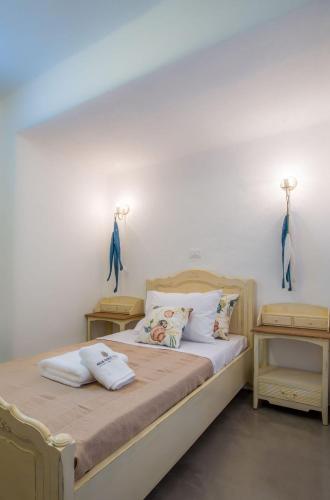 a bedroom with a bed with two lamps on the wall at Deluxe Paros Villa Grand Villa 4 Bedrooms Wonderful Sea View & Private Pool Golden Beach in Kampos Paros