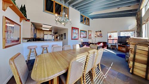 a kitchen and dining room with a wooden table and chairs at Large Spacious Upgraded 4 Bedroom Condo in Mammoth Lakes