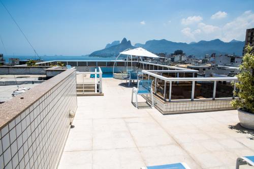 a patio with chairs and a view of the water at Atlantis Copacabana Hotel in Rio de Janeiro