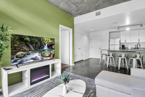 a living room with a flat screen tv on a wall at Centric 2BR In HEART of DTPHX Free Garage Parking in Phoenix