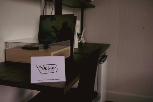 a table with a sign on top of it at The Spinn in Manzanita