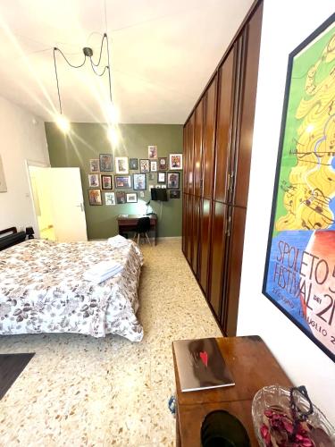 a bedroom with a bed and a desk and a table at Alloggio Primavera in Terni