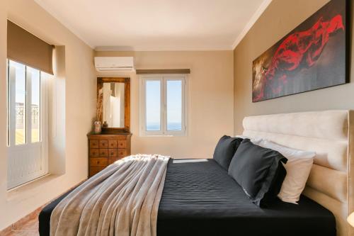 a bedroom with a bed and a large window at Lassi Seaview Villa Private Pool Villa Efrosini Short Walk To Resort Centre in Kefallonia