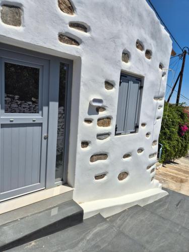 a building with a wall with holes in it at Koko Room's 1 in Kithnos