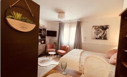 a bedroom with a bed and a living room at Le Velvet - Plein centre Vannes in Vannes