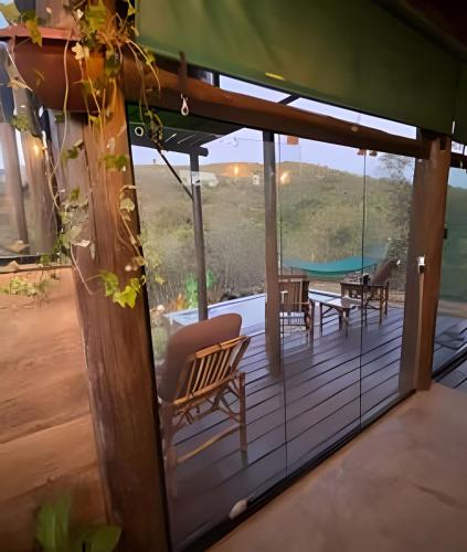 a screened in porch with a view of a pool at Espaço Gaia in Santana do Riacho