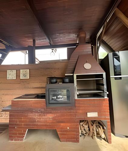a kitchen with a brick oven in a house at Espaço Gaia in Santana do Riacho