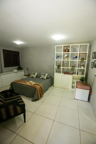 a bedroom with a bed and a couch in it at Chalés serra linda in Bananeiras