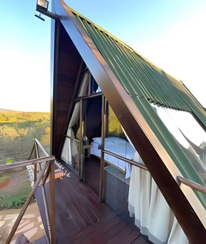 a room with a hammock on a roof at Espaço Gaia in Santana do Riacho