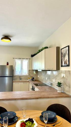 a kitchen with a table with plates on it at Serene Livadi Apartment in Kýthira