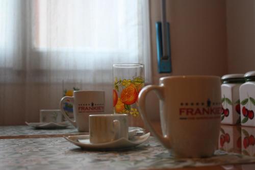 a table with cups and saucers on a table at Bridge To Venice in Venice
