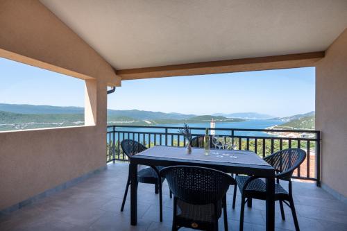 a dining room with a table and chairs on a balcony at Gabriel in Neum