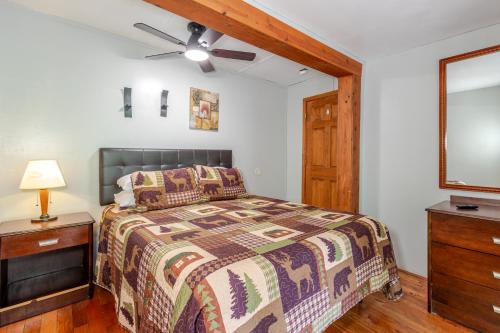a bedroom with a bed and a ceiling fan at Qualla Cabins and Motel Cherokee near Casino in Whittier