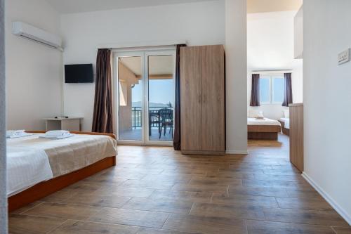 a hotel room with a bed and a balcony at Gabriel in Neum